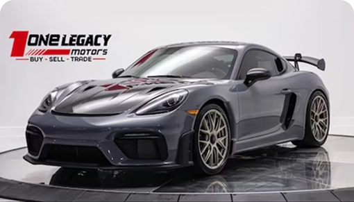 Grey 2025 Porsche 718 Cayman GT4 RS on gold wheels, photographed on the One Legacy Motors turntable