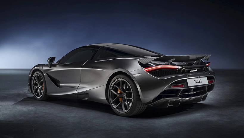 Rear three-quarter view of a grey McLaren 720S showing its active rear wing and 720S badge