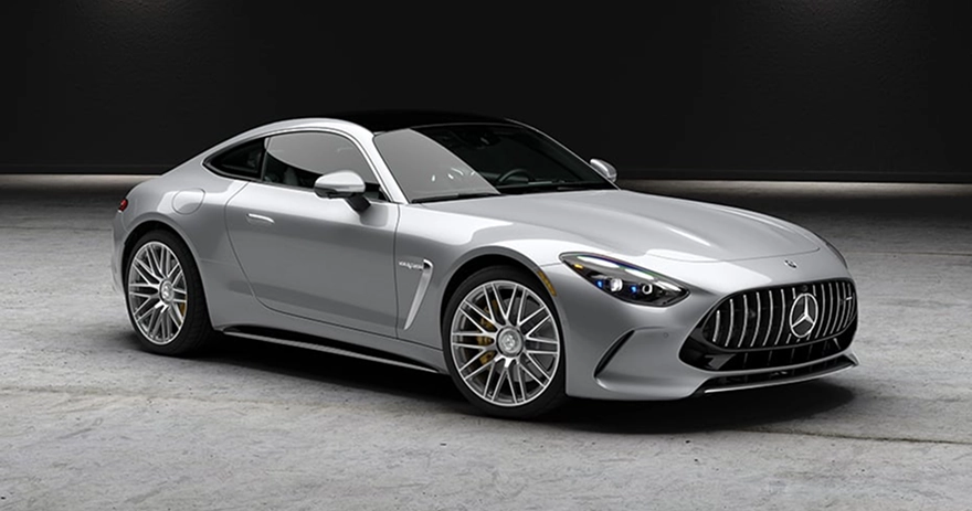 Silver Mercedes-AMG GT coupe in a grey studio, seen from the front three-quarter