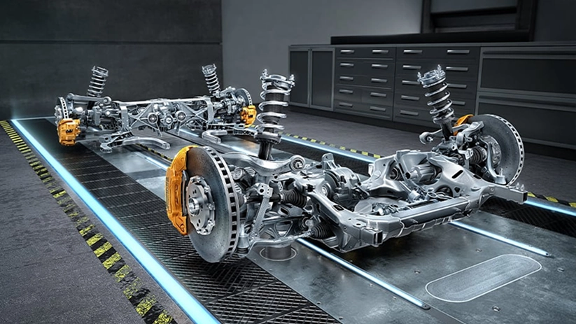 Bare Mercedes-AMG chassis on a stand showing the multilink suspension arms and gold brake calipers