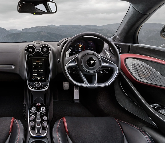 McLaren GT cockpit with red leather trim, a portrait touchscreen and a digital gauge cluster