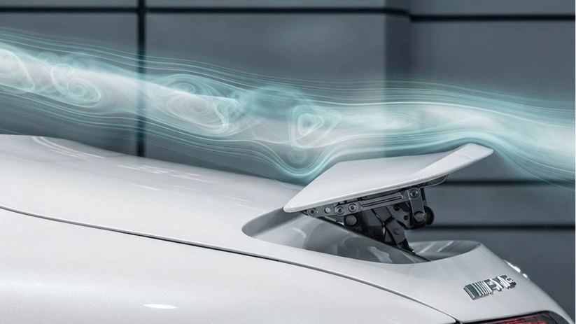 Airflow visualisation streaming over the raised rear spoiler of a silver Mercedes-Benz
