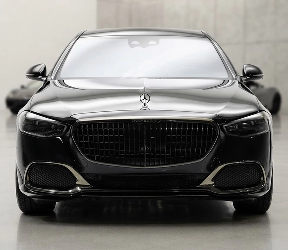 Black Mercedes-Maybach S-Class in profile against a white studio wall