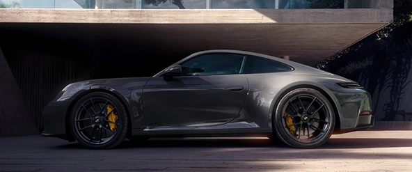 Grey Porsche 911 GT3 in profile, parked in the shade of a concrete overpass