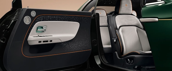 Rolls-Royce Spectre with a coach door open, showing the pale grey seats and starlight door panel