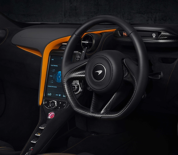 McLaren 720S cockpit with orange accents, a portrait touchscreen and a carbon fibre console