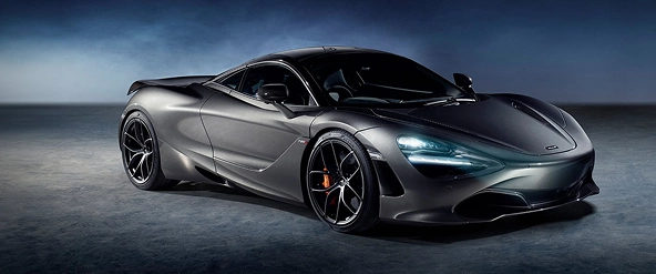 Grey McLaren 720S in profile in a dark studio