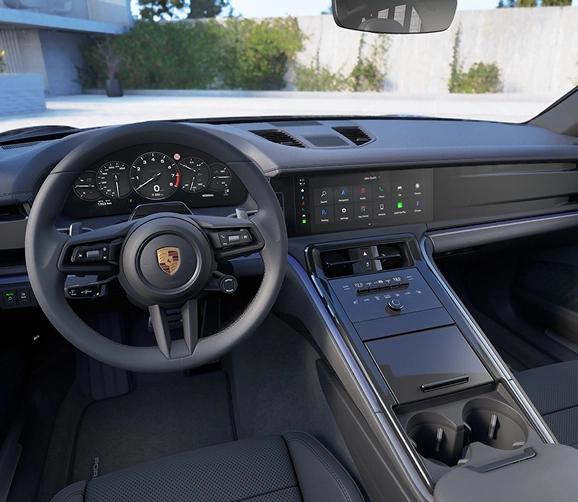 Porsche Panamera cockpit with its analogue-style gauge cluster, curved centre screen and grey leather seats