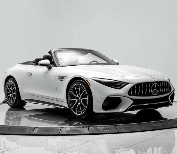 White Mercedes-AMG SL roadster with the roof down on the One Legacy Motors turntable