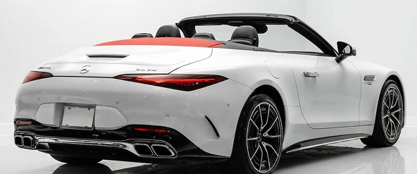 Rear three-quarter view of a white Mercedes-AMG SL with its red soft top raised