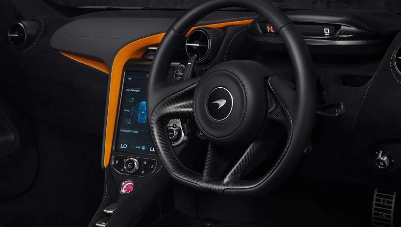 McLaren 720S cockpit with orange trim, a portrait touchscreen and drive mode controls on the console