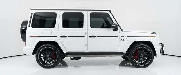 White Mercedes-AMG G 63 in profile in a white studio
