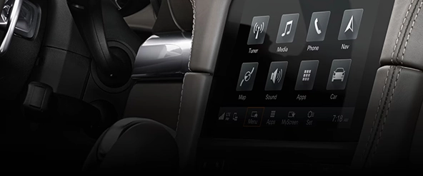 Porsche 718 Cayman centre touchscreen showing tuner, media, phone and navigation tiles