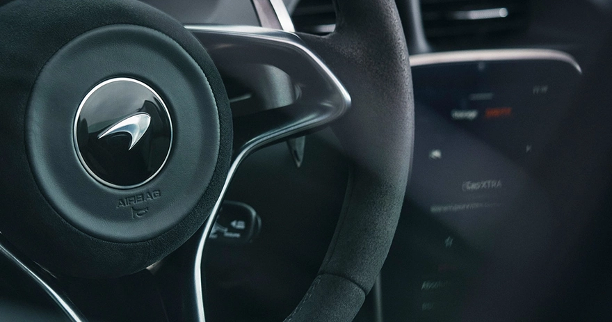 McLaren Artura steering wheel with the marque's logo and an Alcantara rim