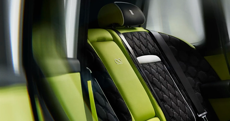 Rolls-Royce Cullinan interior with lime green leather seats and black quilted panels