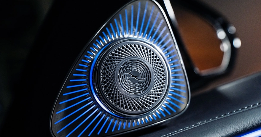 Burmester speaker grille glowing blue in a Mercedes-Benz door trim