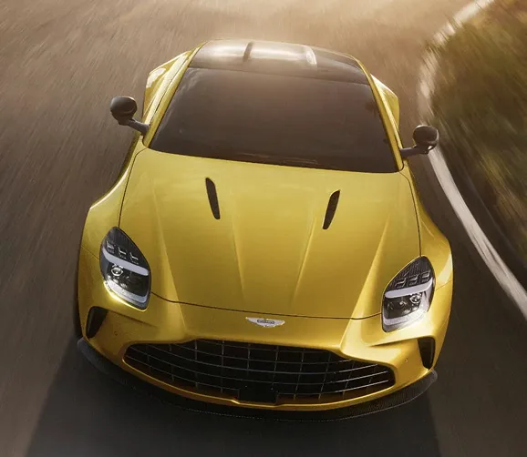 Head-on view of a yellow Aston Martin Vantage at speed
