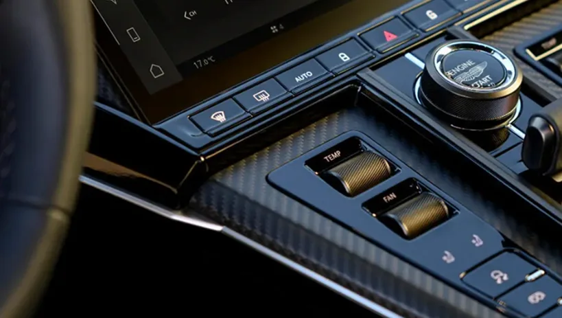 Aston Martin centre console touchscreen with rotary drive controls below it