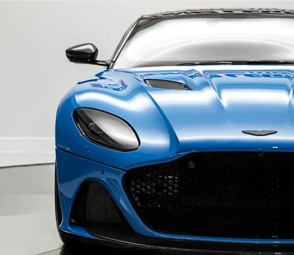 Front detail of a blue Aston Martin DBS Superleggera in a studio