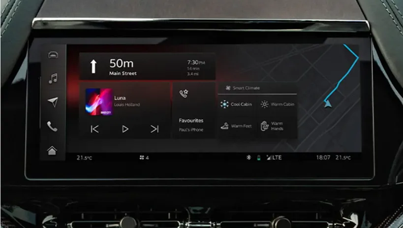 Aston Martin infotainment screen showing turn-by-turn navigation alongside media controls