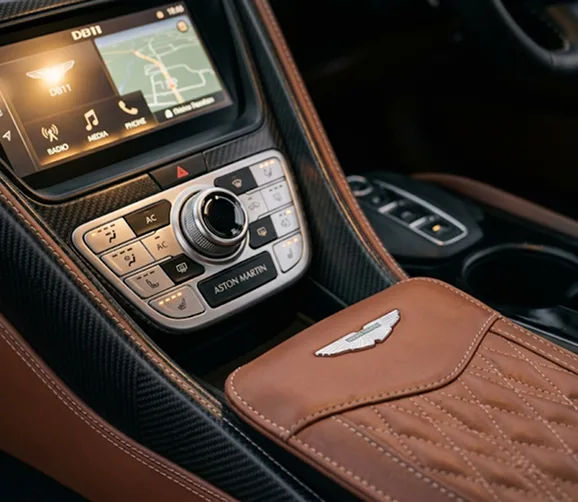 Aston Martin DB11 centre console in tan leather with its rotary controls