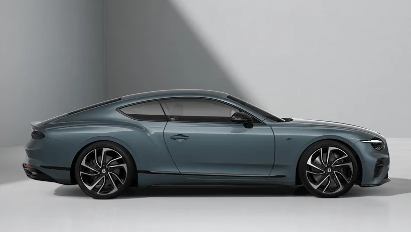 Grey Bentley Continental GT in profile in a pale studio