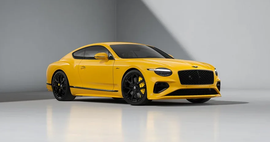 Yellow Bentley Continental GT photographed in a pale studio