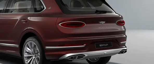 Rear three-quarter view of a dark red Bentley Bentayga EWB