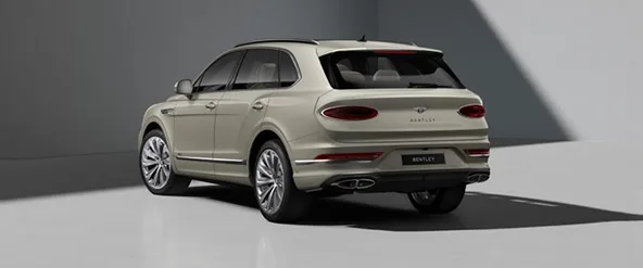Rear three-quarter view of a cream Bentley Bentayga
