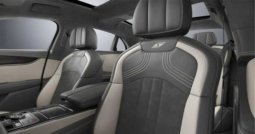 Rear cabin of a Bentley Flying Spur with cream and grey quilted seats