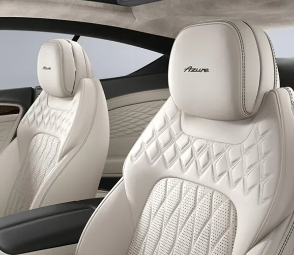 Cream quilted Bentley seats beneath a panoramic glass roof