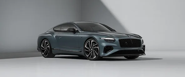 Dark teal Bentley Continental GT photographed in a pale studio