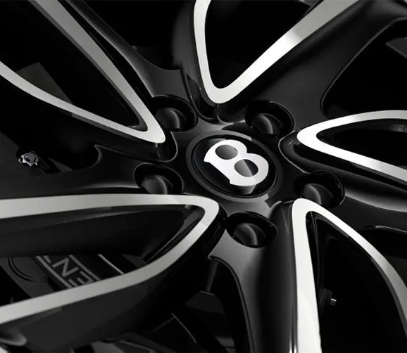 Close-up of a Bentley wheel with the winged B centre cap