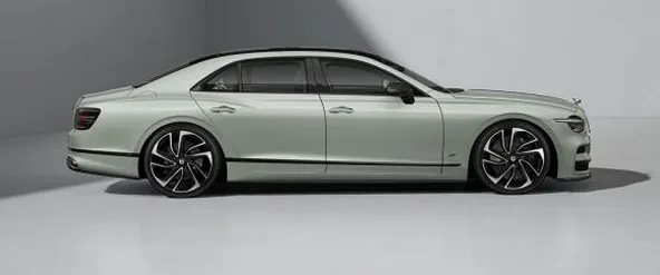 Pale green Bentley Flying Spur in profile in a studio