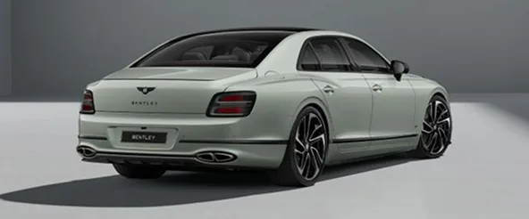 Rear three-quarter view of a pale green Bentley Flying Spur