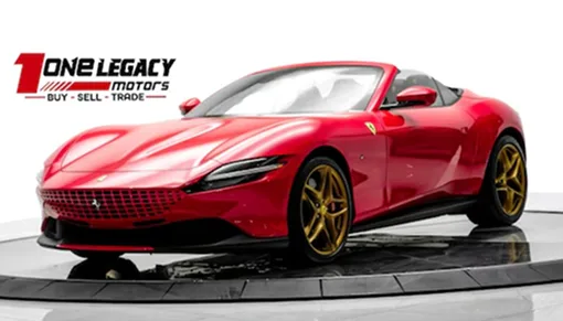 Red 2024 Ferrari Roma Spider on gold wheels with the top down, photographed on the One Legacy Motors turntable