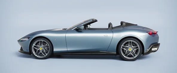 Side profile of a silver-blue Ferrari Roma Spider with the roof down