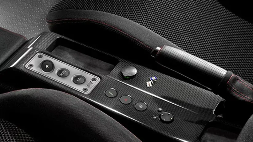 Close-up of a Ferrari gear selector and centre console controls in black leather