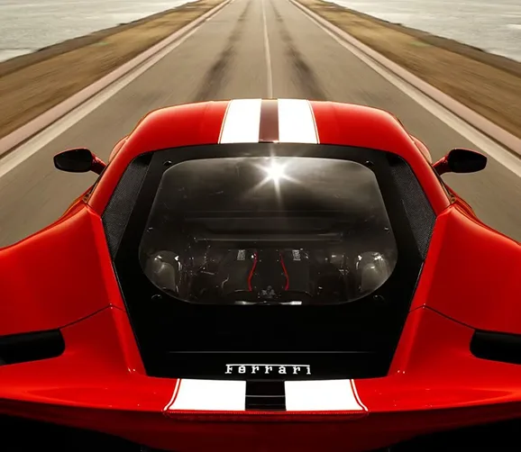 Head-on view of a red Ferrari 488 Pista showing its S-Duct hood and racing stripes