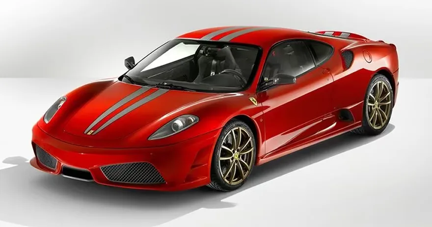 Red Ferrari F430 Scuderia photographed against a plain white studio background