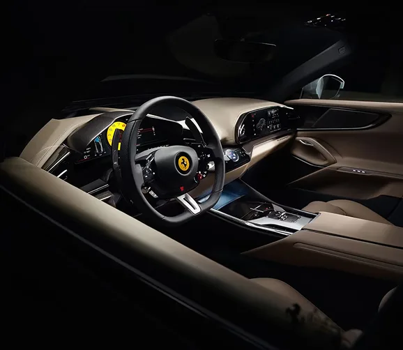 Ferrari Purosangue cockpit with a yellow-accented steering wheel and tan leather dashboard