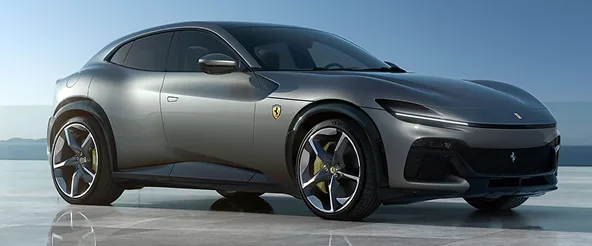 Side profile of a grey Ferrari Purosangue on a pale studio floor