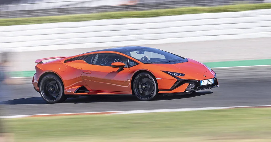 Orange Lamborghini Huracan Tecnica cornering on a race circuit