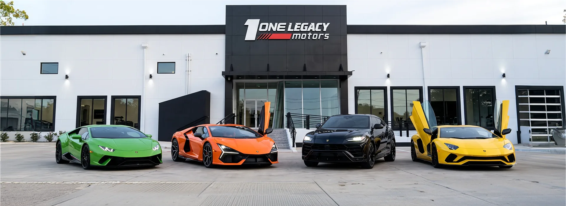 Green, orange, black and yellow Lamborghinis parked side by side outside the One Legacy Motors showroom in Carrollton, Texas