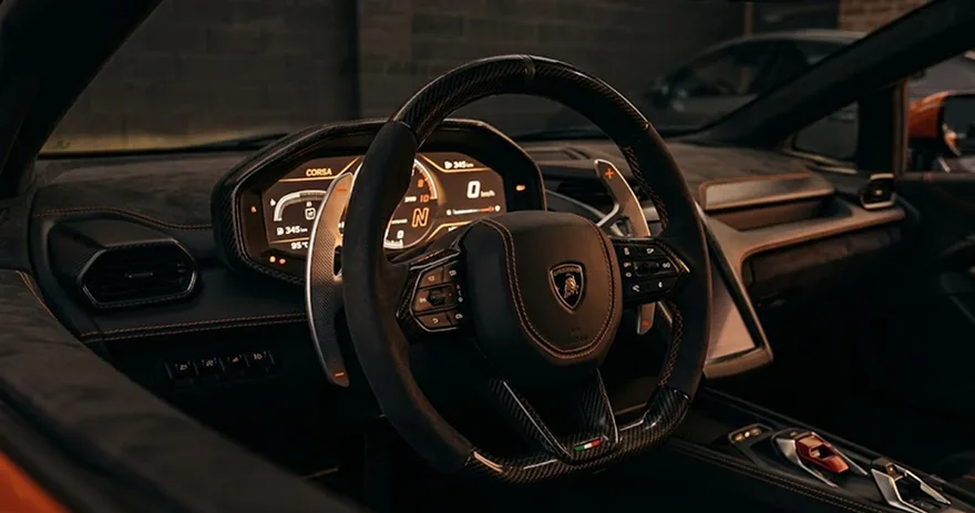 Close-up of a Lamborghini steering wheel and brown leather cockpit