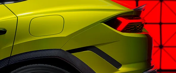 Rear quarter detail of a lime green Lamborghini Urus showing the wheel and taillight