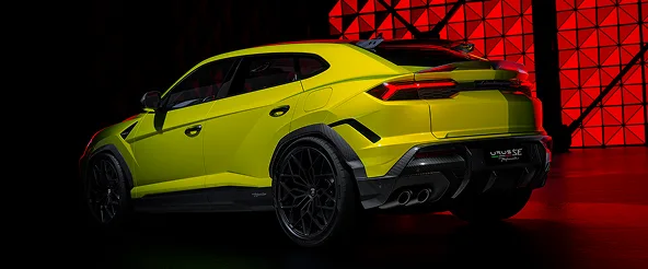 Rear three-quarter view of a lime green Lamborghini Urus on a red-lit set