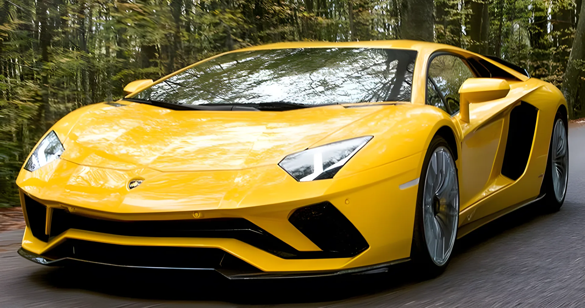 Yellow Lamborghini Aventador S driving along a forest road in autumn