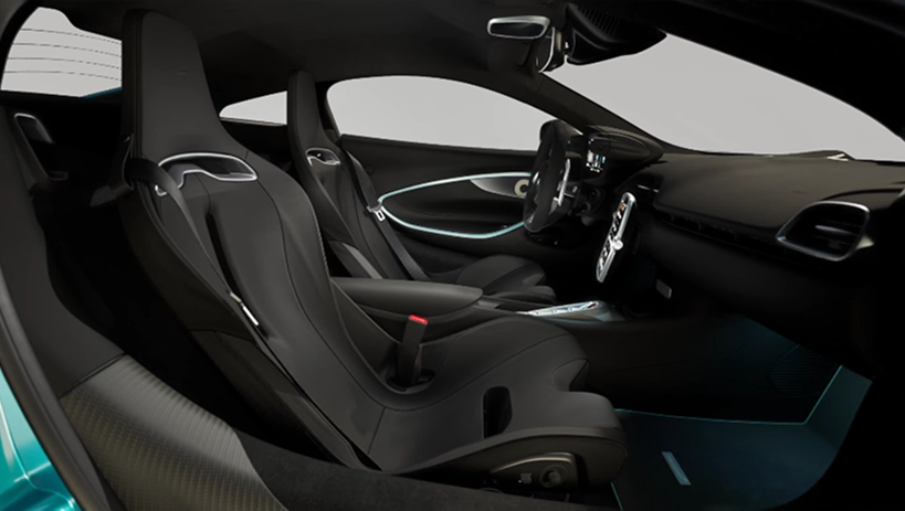 McLaren Artura cabin seen through the open passenger door, with black bucket seats and the steering wheel beyond